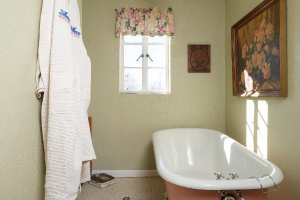 This unique suite features beautiful antique furniture, period decor, and a wonderful 1923 clawfoot bathtub.