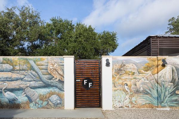 Art wall featuring local flora and fauna welcomes you.