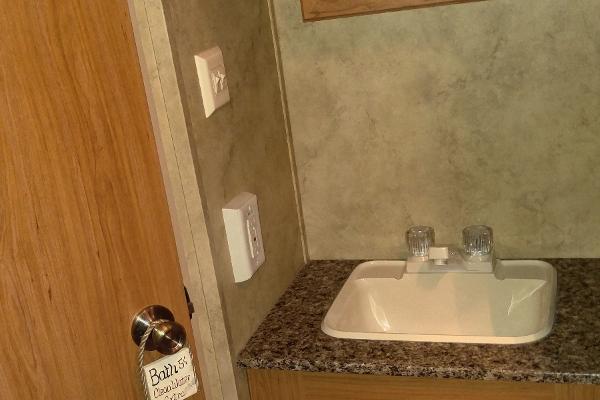 Bathroom Sink, Cabinet, and Mirror next to bathroom