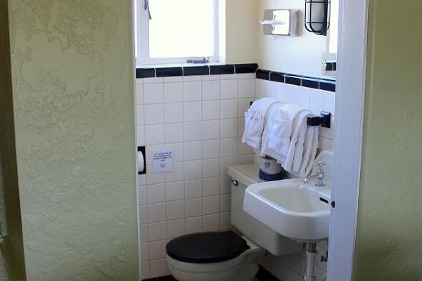 The bathrooms feature original tilework, fixtures, and step-in shower.