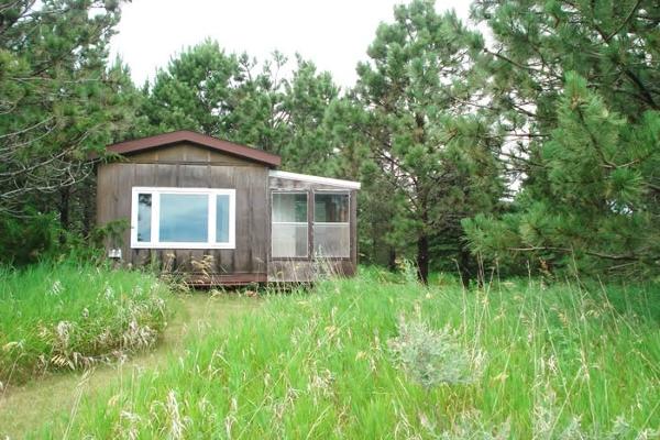 Hermitage Cabins are powered with running water, heat and air conditioning.  Basic cooking: hot plate and microwave.  Single bed, recliner chair with ottoman, desk with chair.  Newly remodeled interio