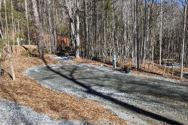 Site #395- 50' L back-in site, FHU, picnic table and fire ring W/ swivel cooking grate.
