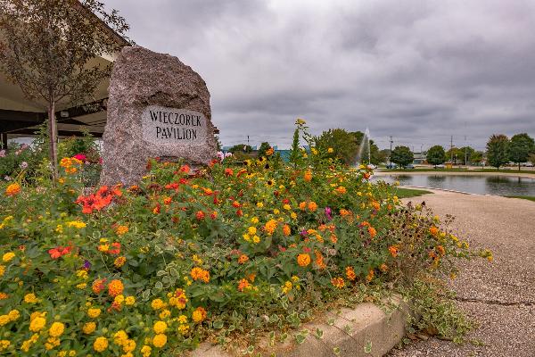 Wieczorek Pavilion sign nested by beautiful flowers