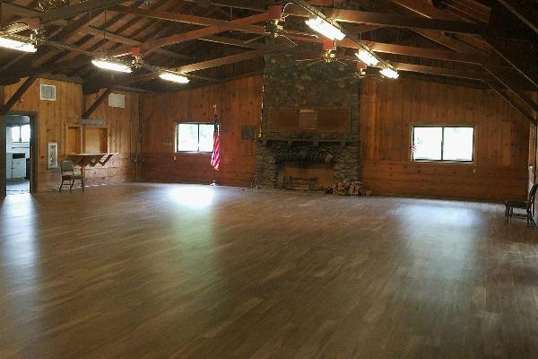 Rustic knotty pine walls, high vaulted ceilings, exposed beams and new flooring. 