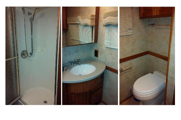 Large Shower with Glass Doors and separate room with toilet, sink and mirror with lots of cabinet space in bathroom