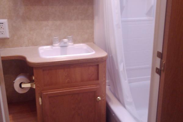 Full Bathroom with tub/shower combo, toilet and sink w/vanity and mirror