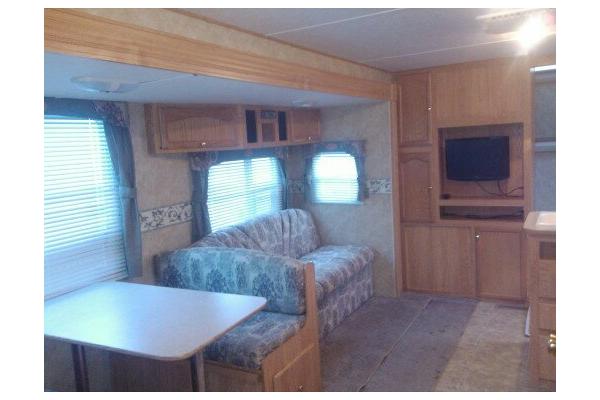 Living Area with couch and dinette table that converts to twin beds and a 26